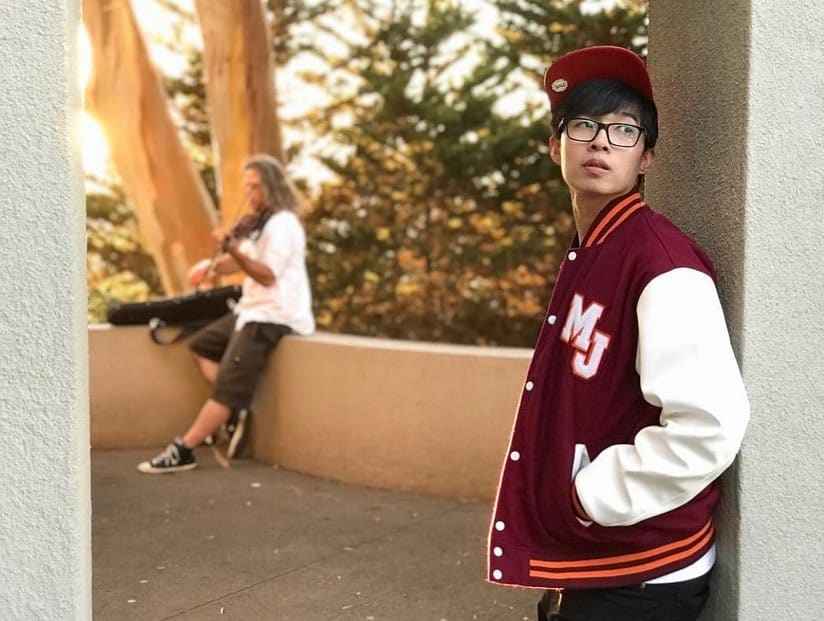 student wearing maroon and white leather sleeves varsity jacket clothoo
