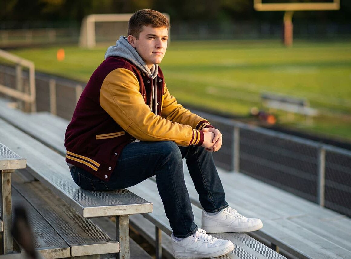 Senior class student sitting in the field bleachers