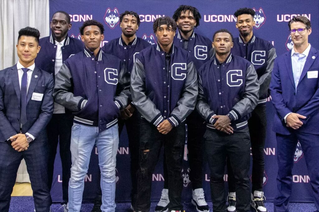 Athletics wearing varsity jacket in school colors