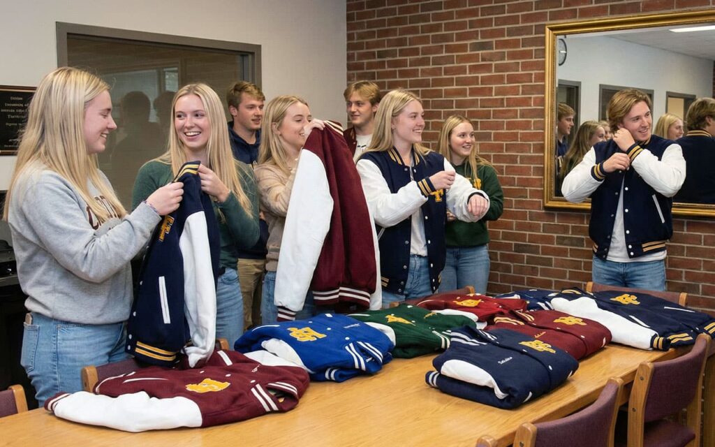 Students checking varsity letterman jackets design, sizes and colors