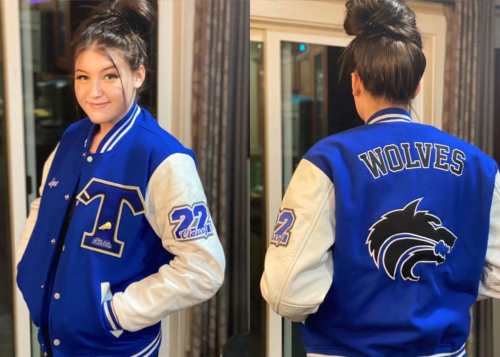 American high school student wearing royal blue senior jacket