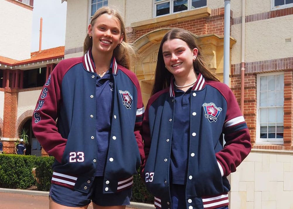 Class of 23 seniors in maroon and white varsity jackets