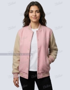 Woman wearing baby pink and beige wool varsity jacket open over a white T-shirt, casual front view